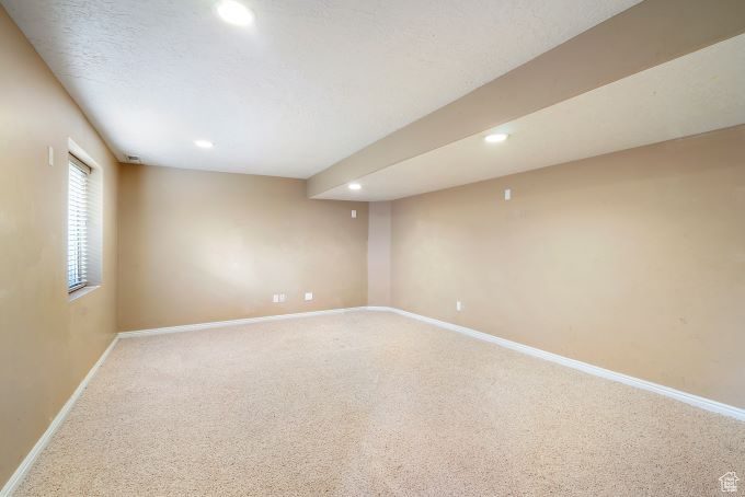 Spare room featuring carpet floors and a textured ceiling