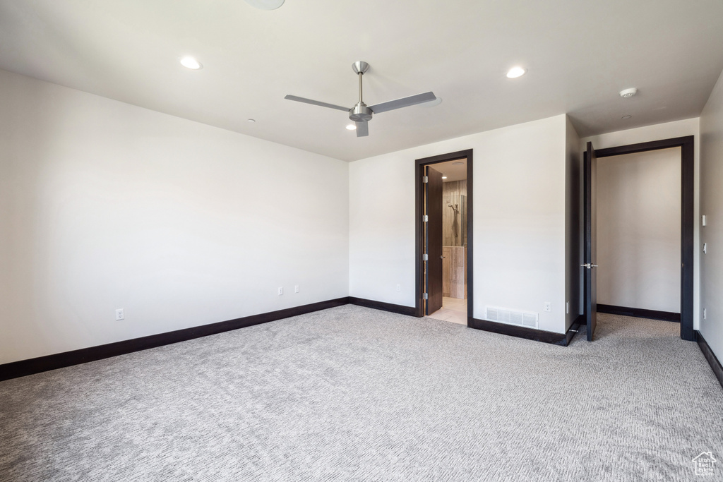 Unfurnished bedroom featuring light colored carpet and ceiling fan