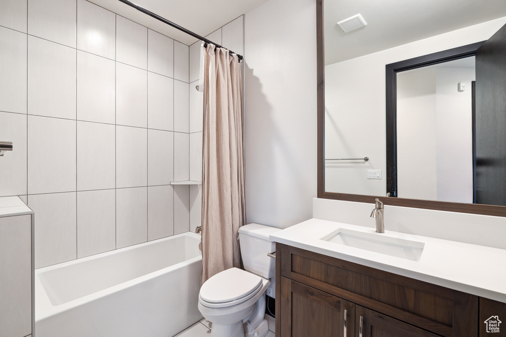 Full bathroom with vanity, toilet, and shower / bathtub combination with curtain