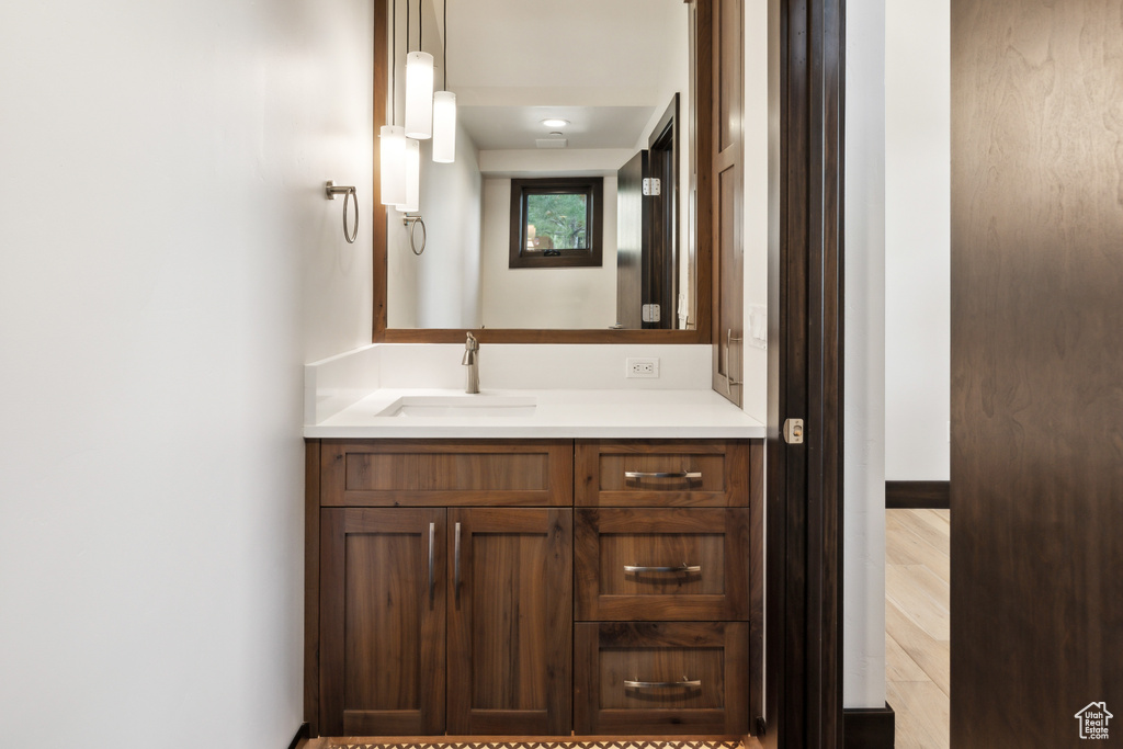 Bathroom featuring vanity and wood-type flooring