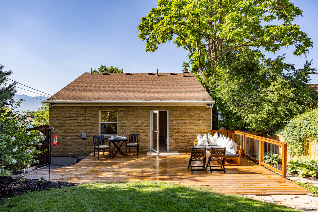 Rear view of property with a deck and an outdoor hangout area