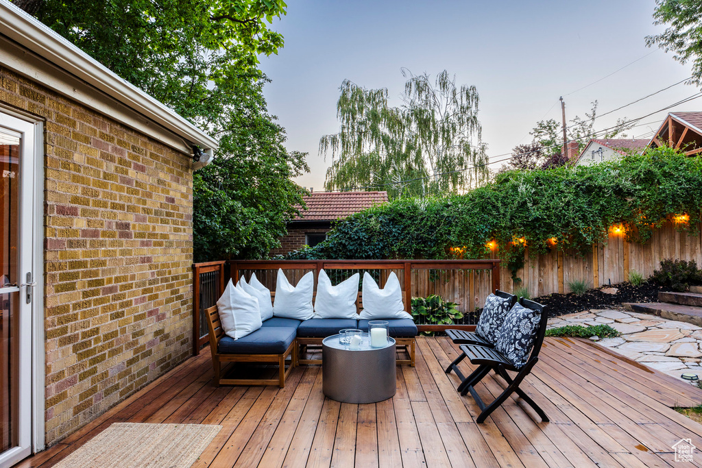 Deck at dusk featuring outdoor lounge area