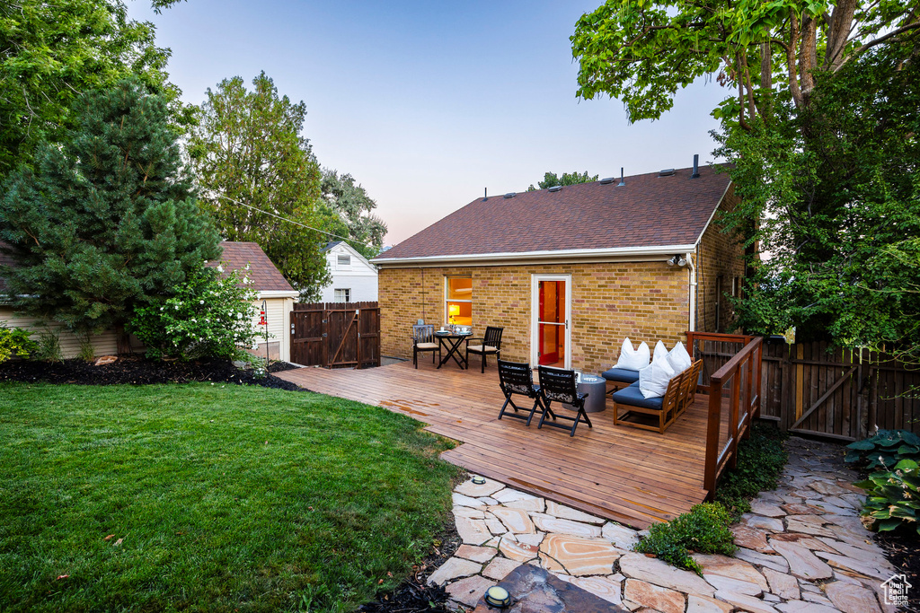 Exterior space with a wooden deck and an outdoor hangout area