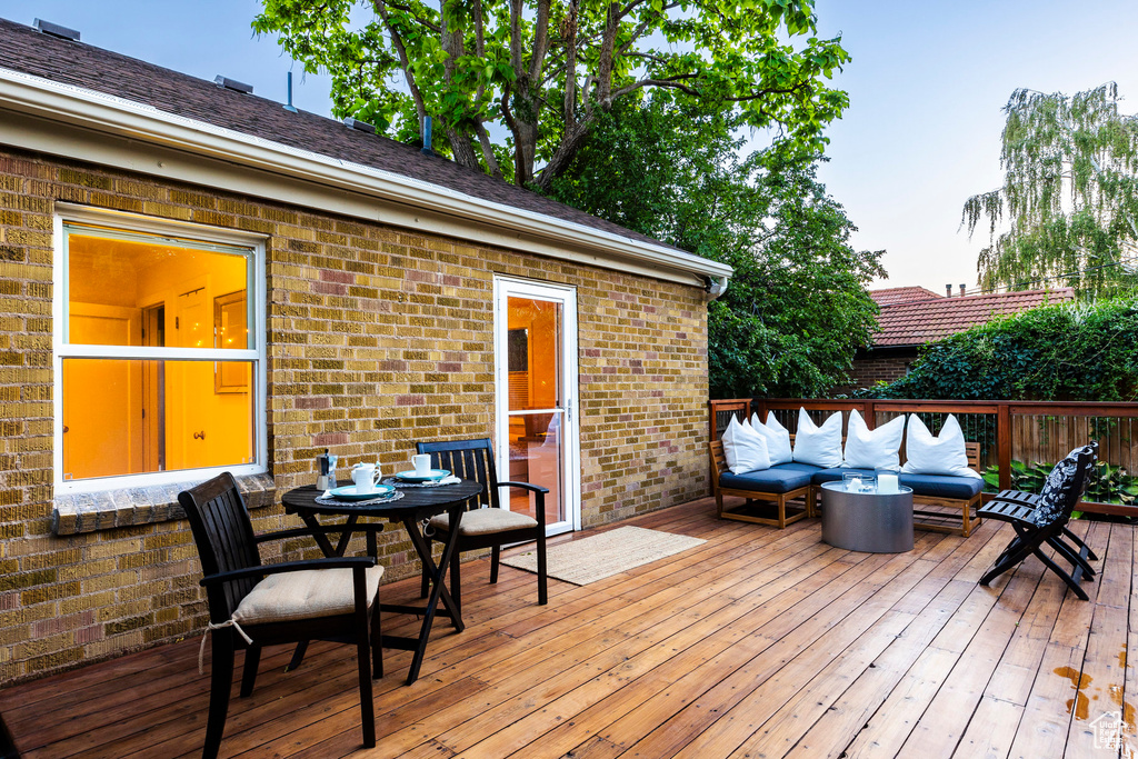 Wooden terrace featuring an outdoor living space