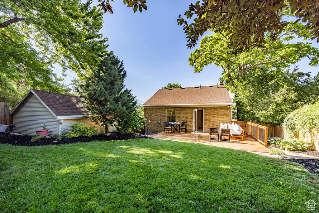 Rear view of property featuring a patio area and a yard