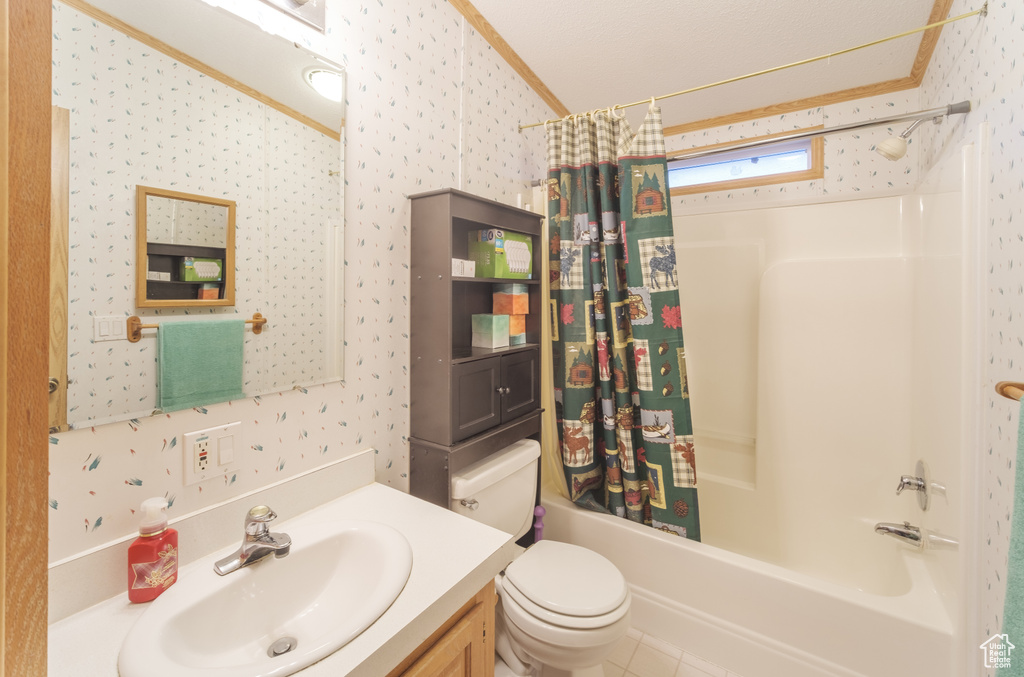 Full bathroom featuring shower / bath combination with curtain, crown molding, tile patterned floors, toilet, and vanity