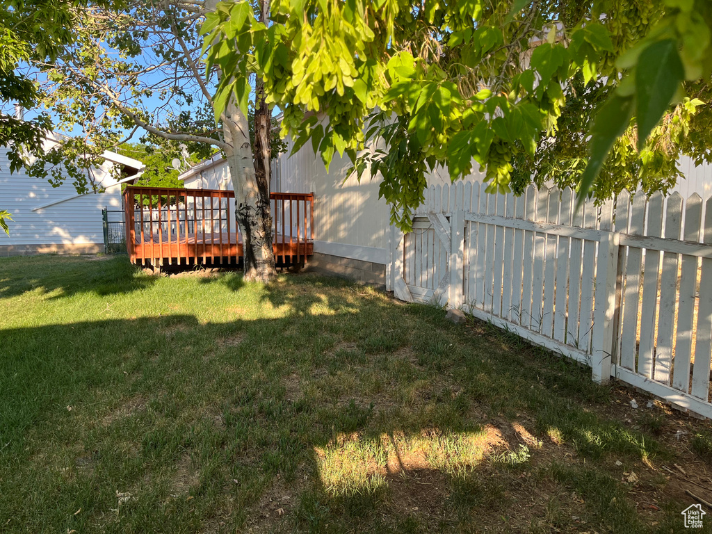 View of yard with a wooden deck