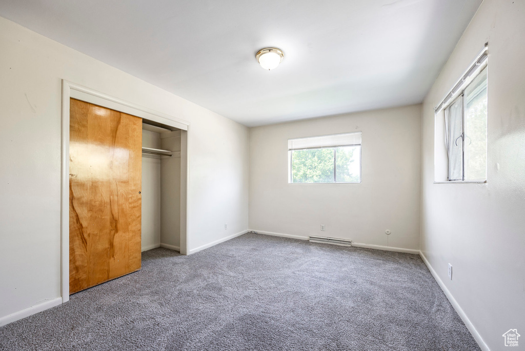 Unfurnished bedroom featuring a closet and carpet flooring