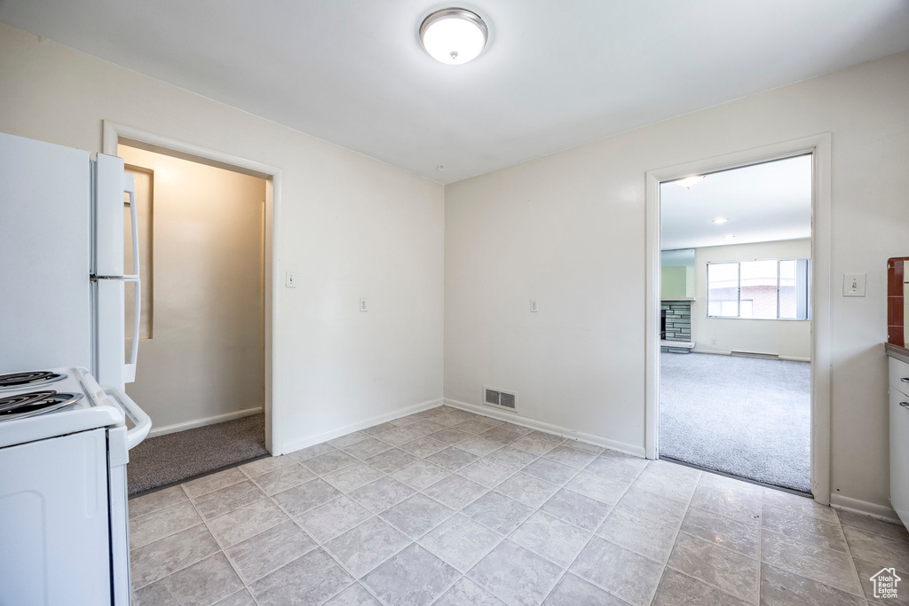 Kitchen featuring white appliances and light tile patterned floors