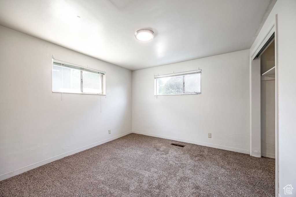 Unfurnished bedroom featuring a closet and carpet floors