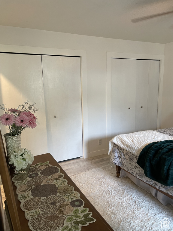 Bedroom with ceiling fan and light wood-type flooring