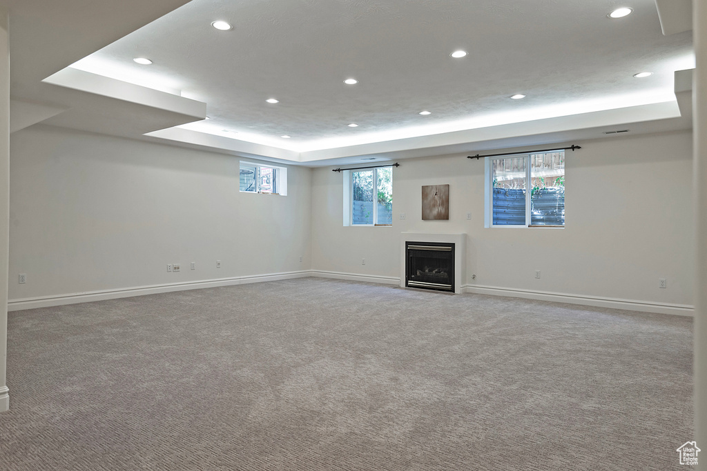 Basement featuring light carpet