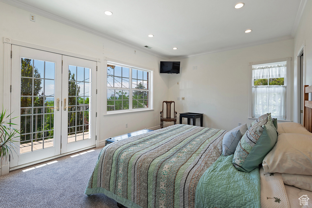 Bedroom with access to exterior, multiple windows, french doors, and carpet flooring