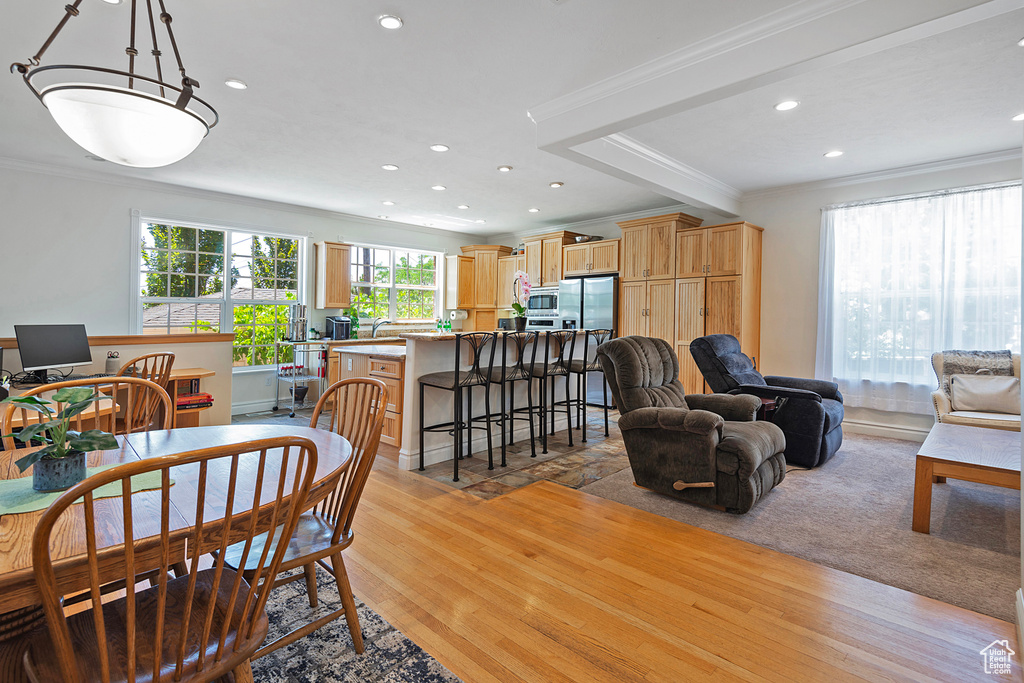 Dining room featuring ornamental molding and light hardwood / wood-style floors