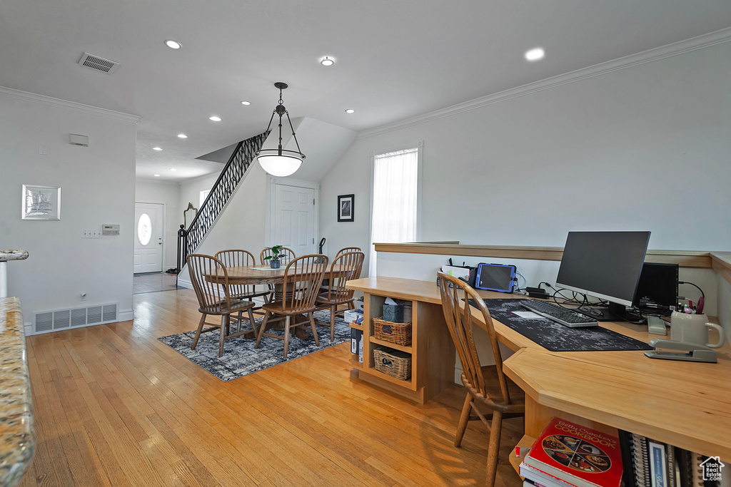 Interior space with light hardwood / wood-style floors and crown molding