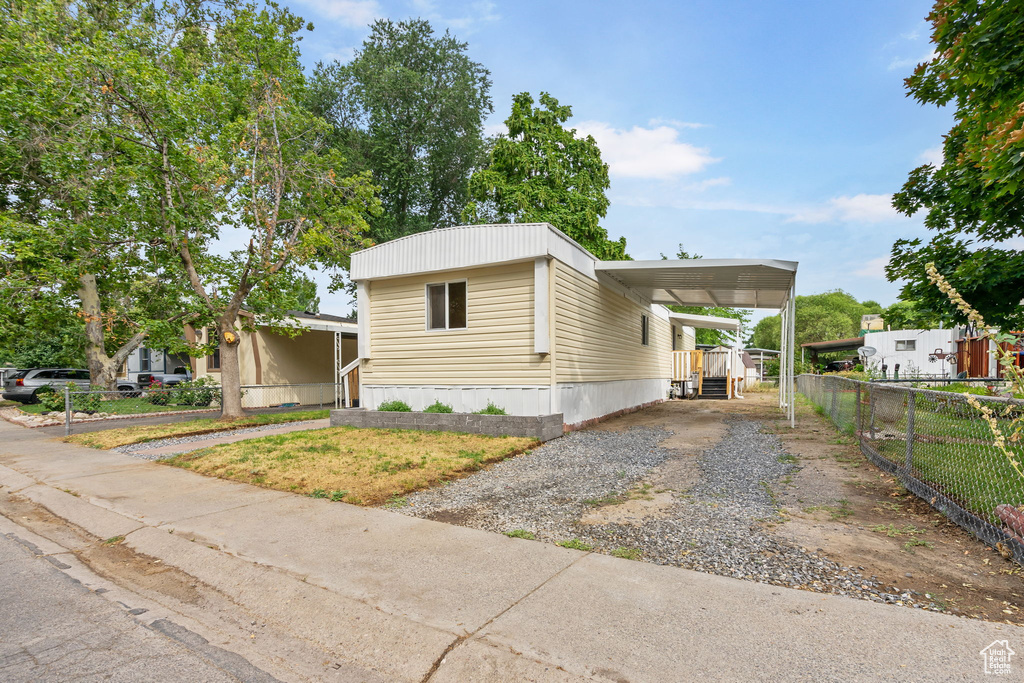 View of front facade with a carport