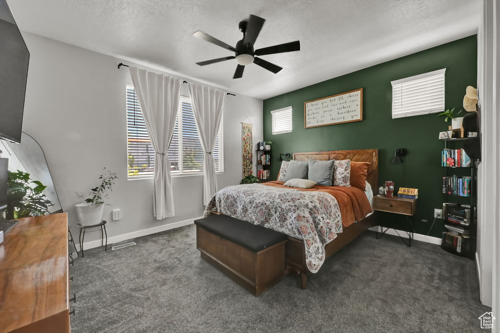 Bedroom featuring carpet floors, a textured ceiling, and ceiling fan