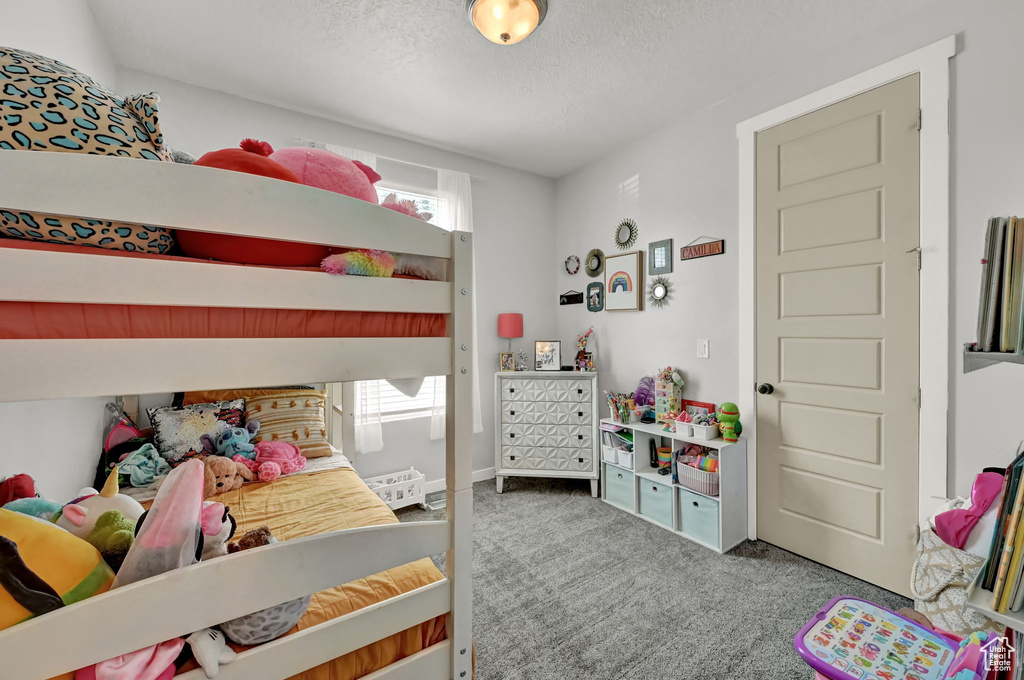 Bedroom with carpet floors and a textured ceiling