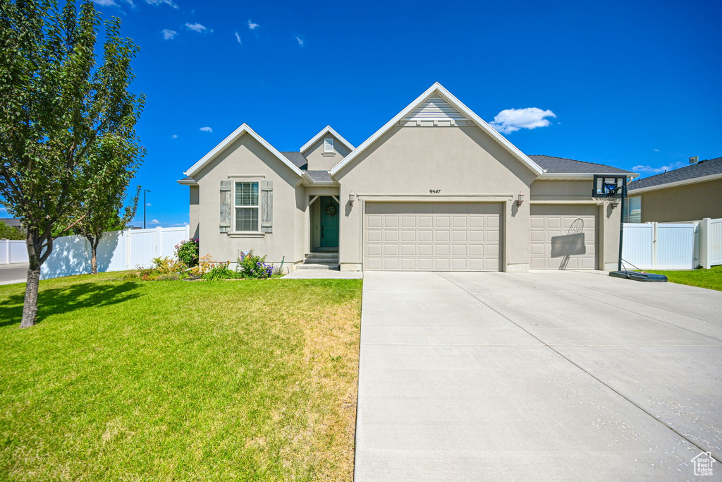 View of front of home featuring a garage and a front lawn