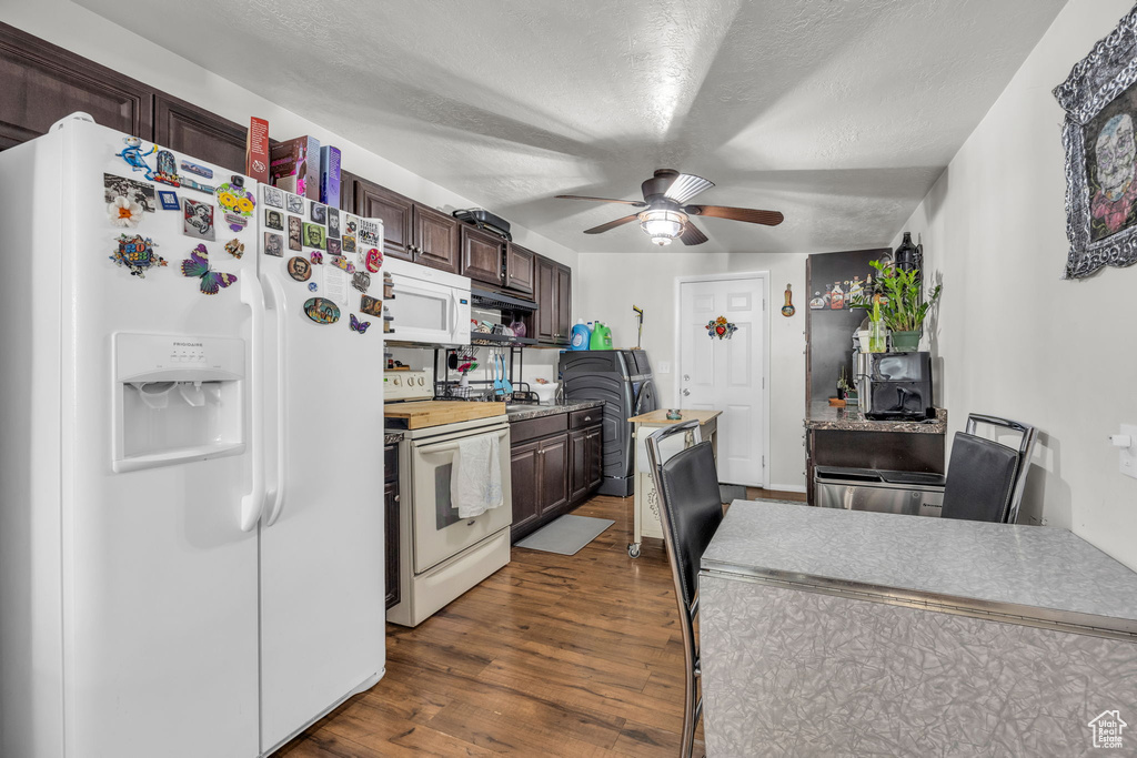 Kitchen featuring white appliances, dark brown cabinets, dark hardwood / wood-style floors, a textured ceiling, and ceiling fan