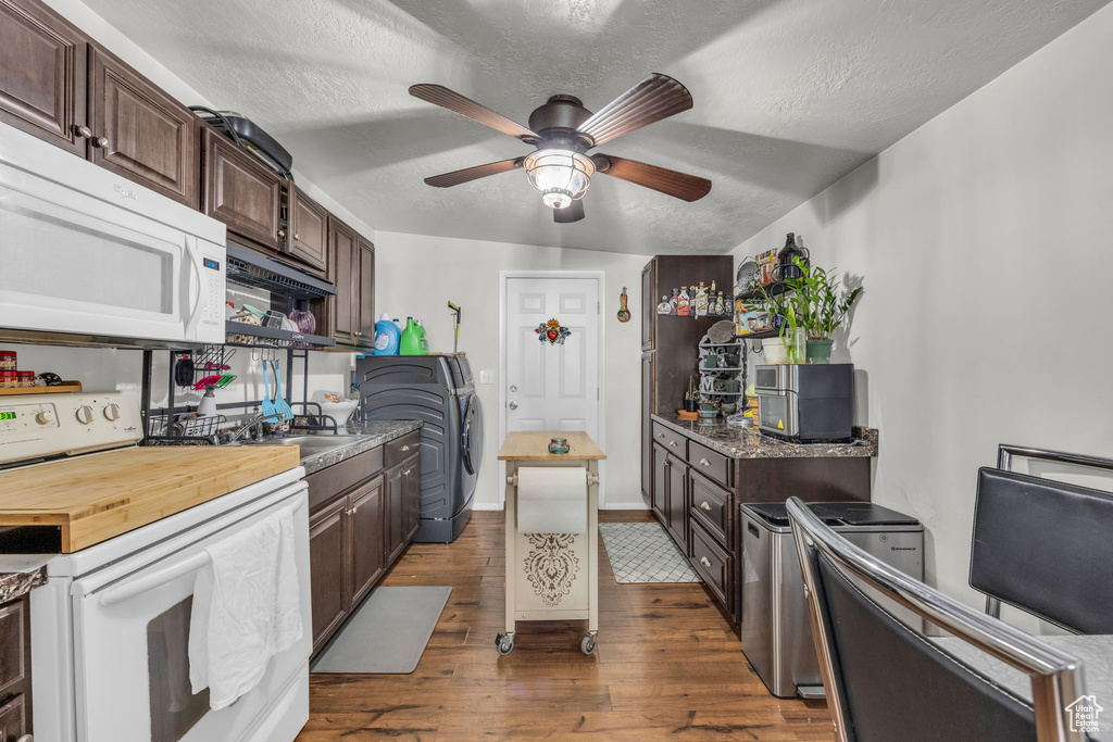 Kitchen featuring hardwood / wood-style flooring, white appliances, dark brown cabinets, a textured ceiling, and ceiling fan