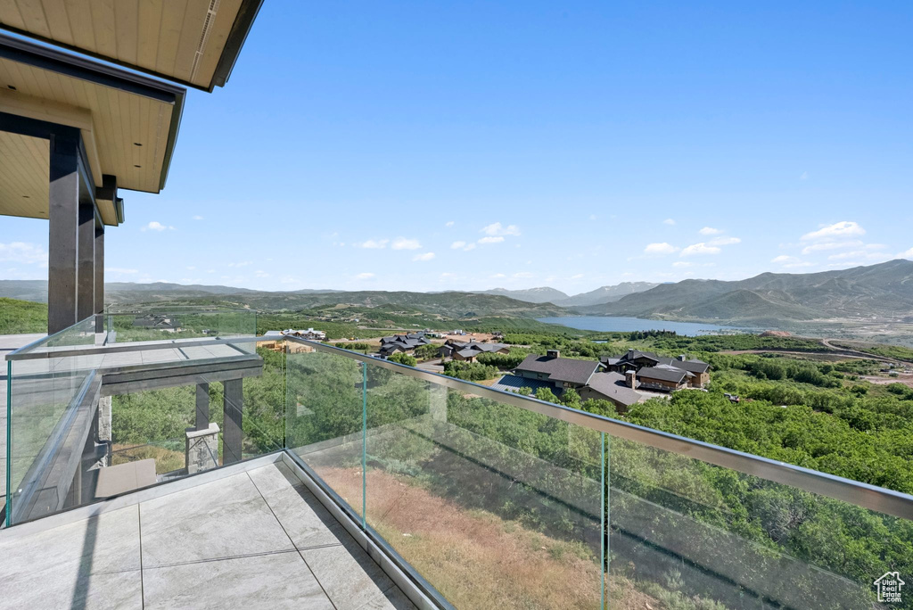 Balcony with a water and mountain view