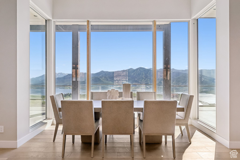 Dining room featuring wood finished floors and a water and mountain view
