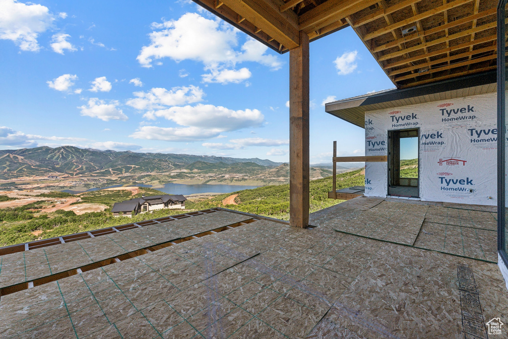 View of patio / terrace with a water and mountain view