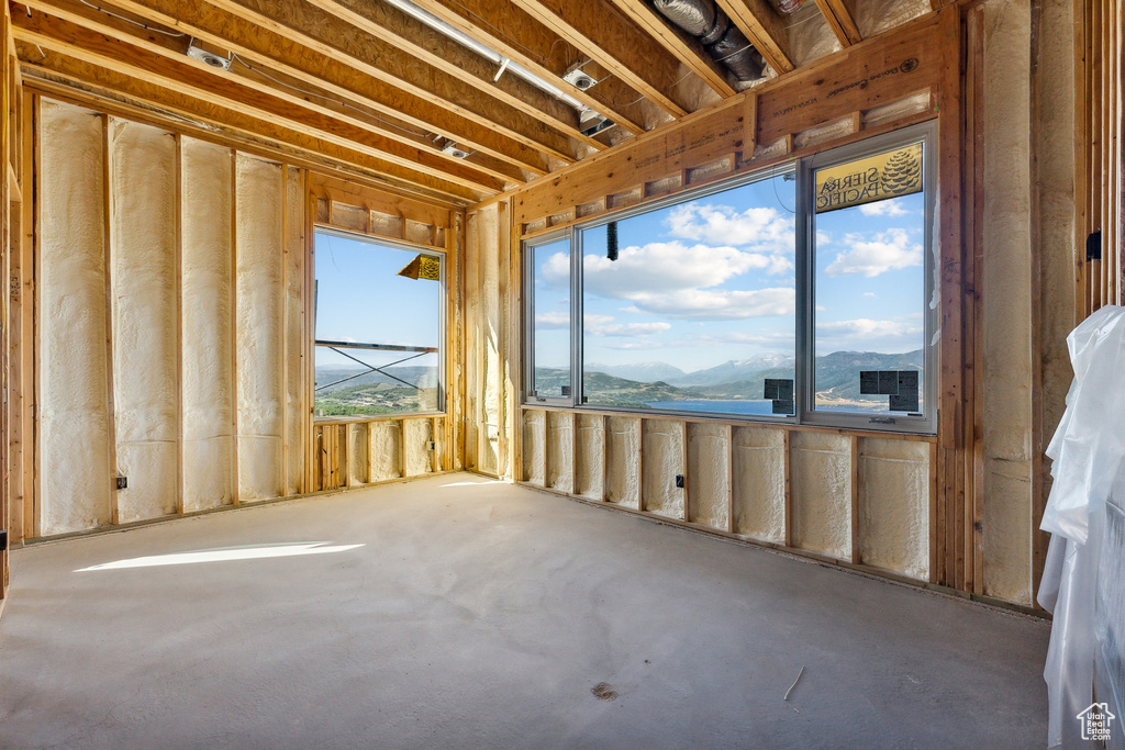 Interior space featuring a mountain view and concrete flooring