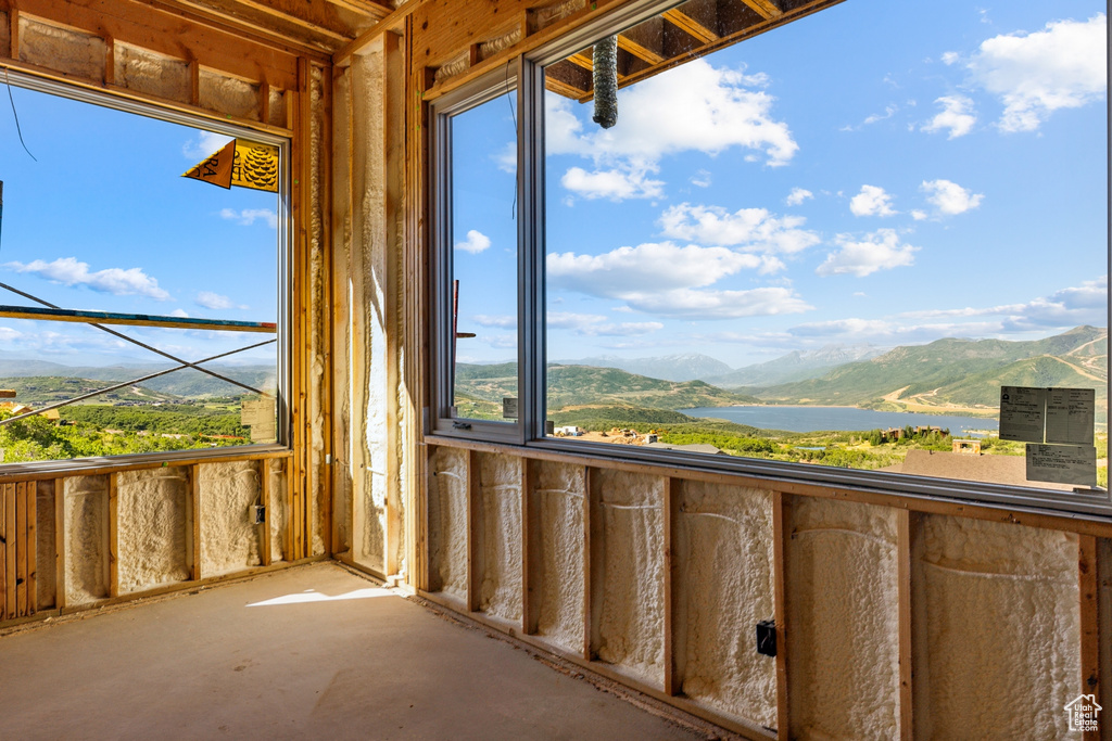 Balcony featuring a water and mountain view