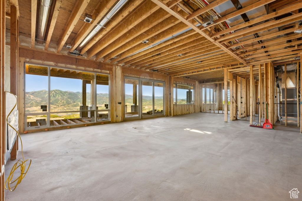 Miscellaneous room with a mountain view and concrete flooring