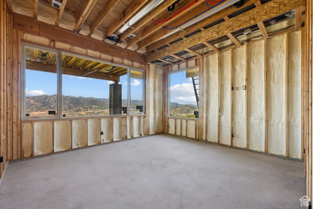 Miscellaneous room with a mountain view and concrete flooring