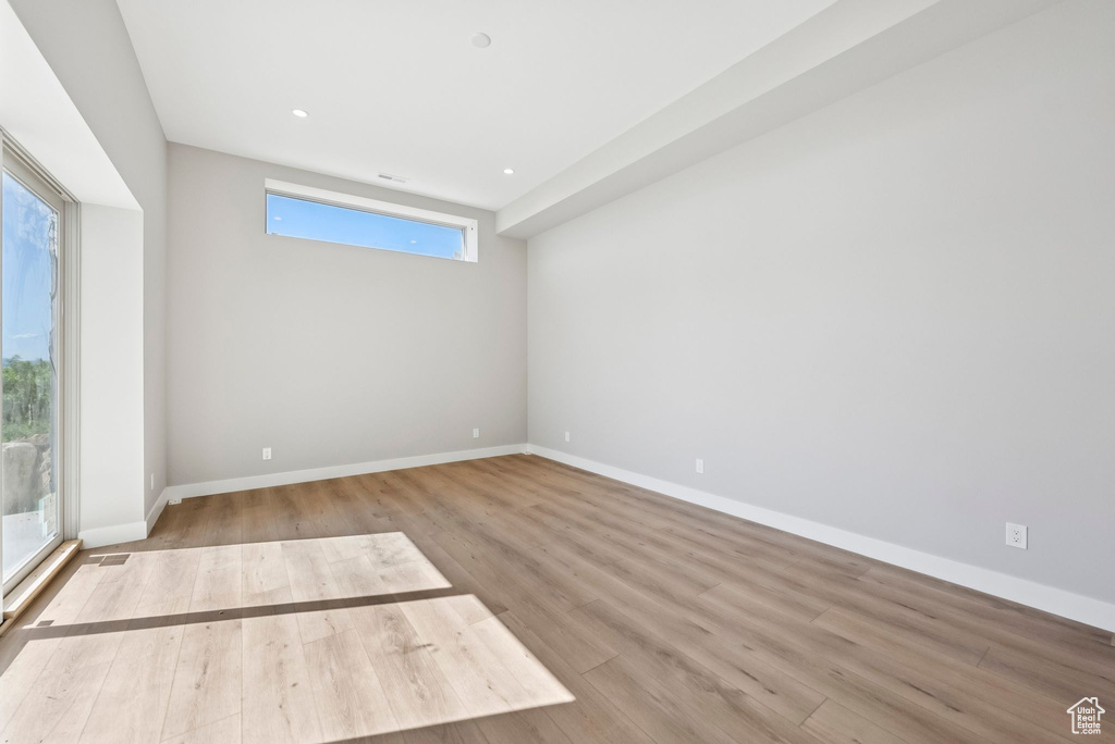Spare room with wood finished floors and recessed lighting