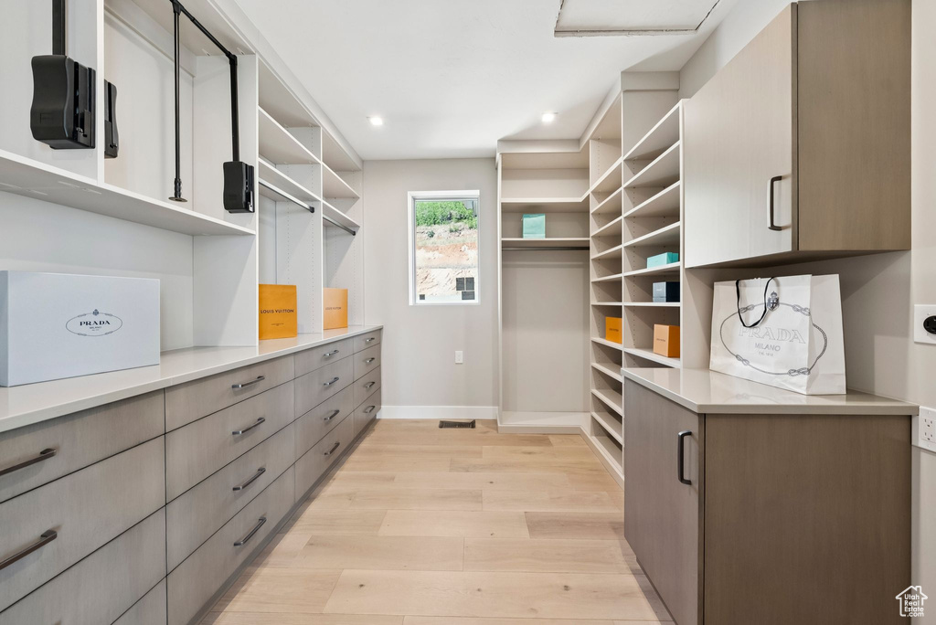 Walk in closet featuring light wood-style floors