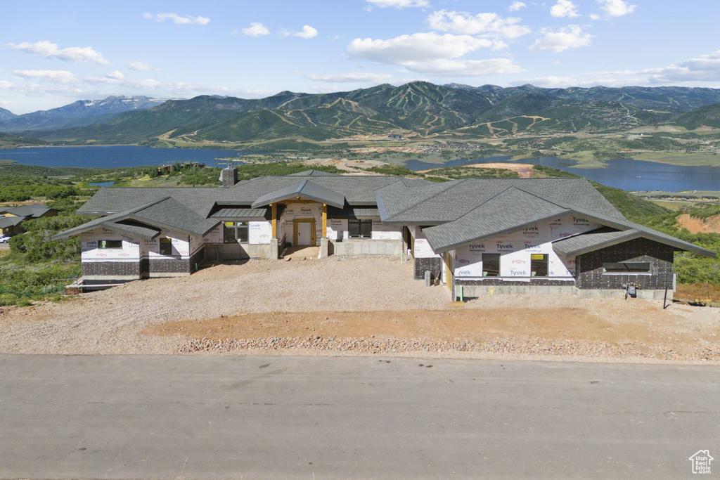 Exterior space featuring a water and mountain view