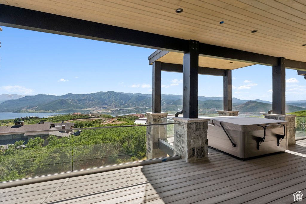 Deck with a water and mountain view