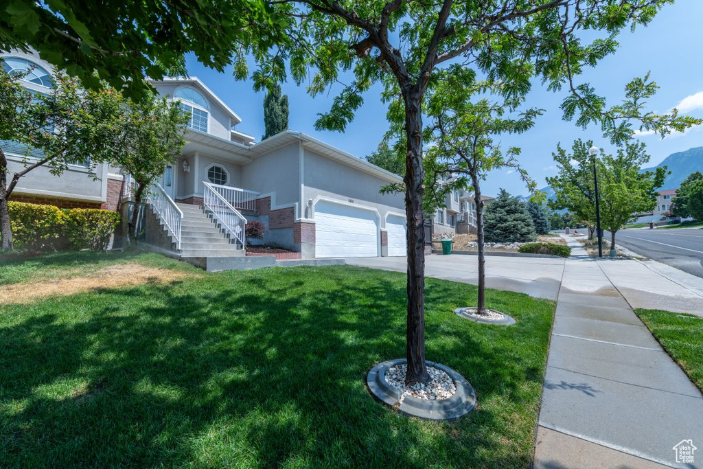 View of side of home featuring a lawn