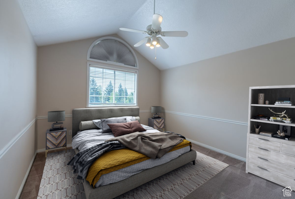 Carpeted bedroom featuring lofted ceiling, a textured ceiling, and ceiling fan