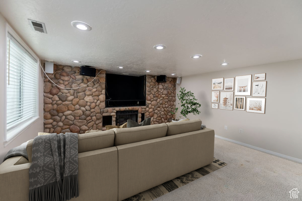 Carpeted living room with a fireplace