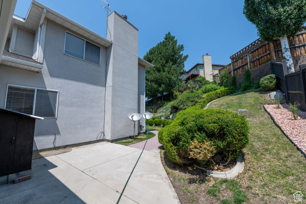 View of community with a patio area and a lawn