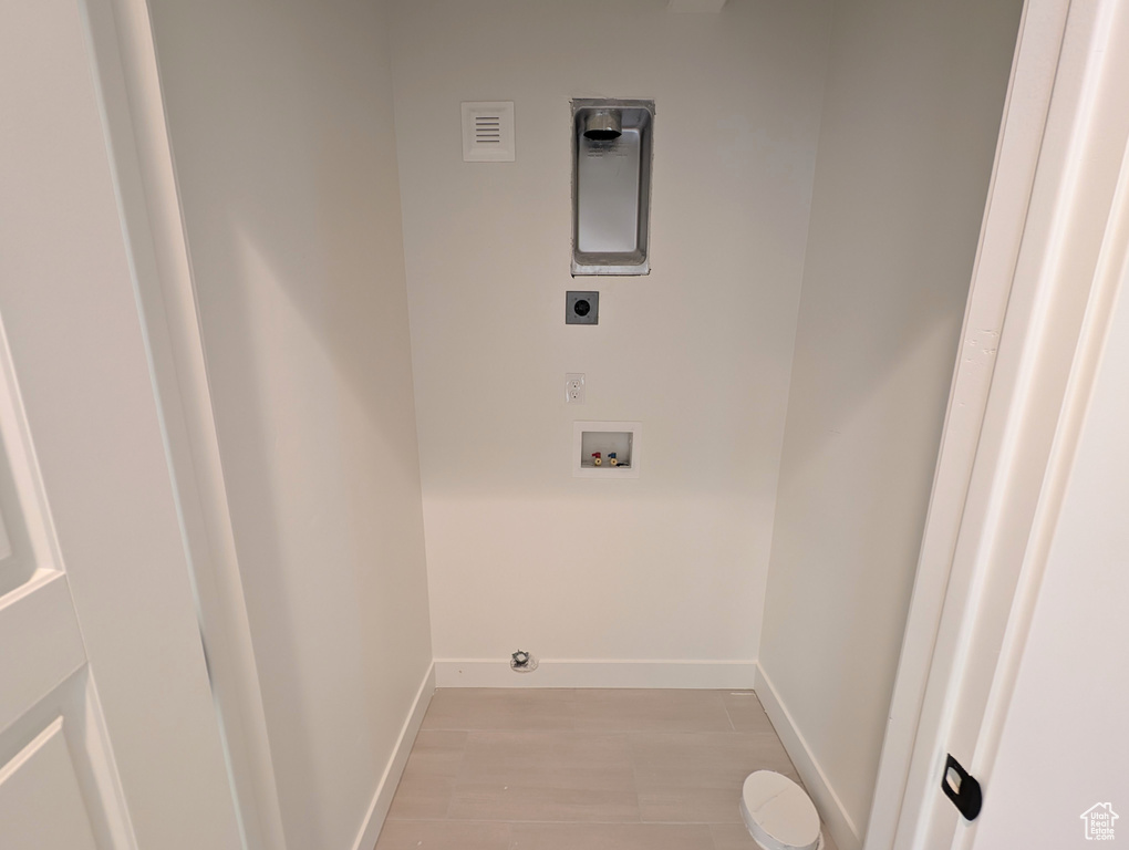 Laundry room featuring washer hookup, light wood-type flooring, and electric dryer hookup