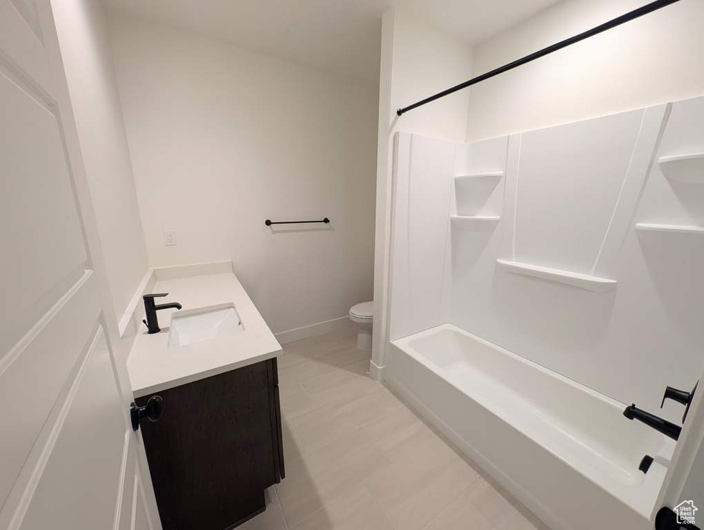 Full bathroom with bathtub / shower combination, vanity, and toilet