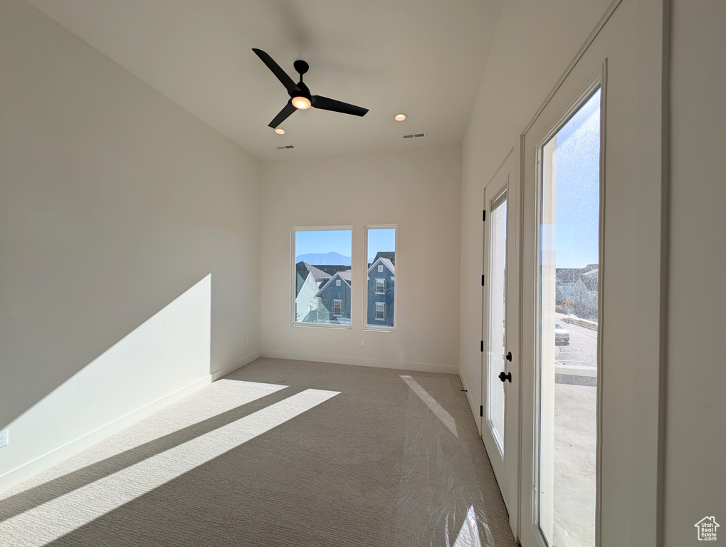 Unfurnished room with ceiling fan and carpet