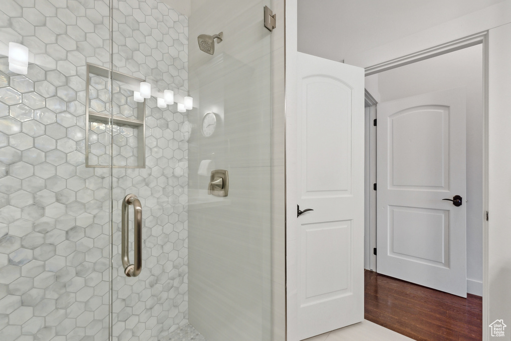 Bathroom with wood-type flooring and walk in shower