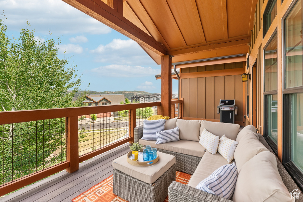 Wooden terrace featuring an outdoor living space