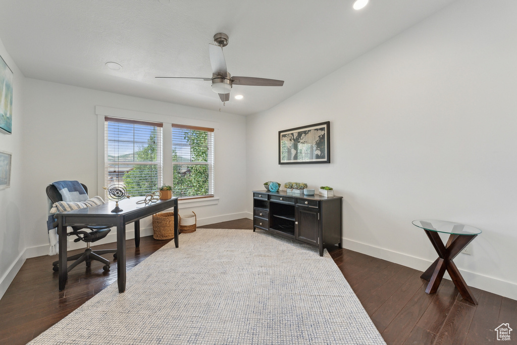 Office area with vaulted ceiling, dark hardwood / wood-style flooring, and ceiling fan