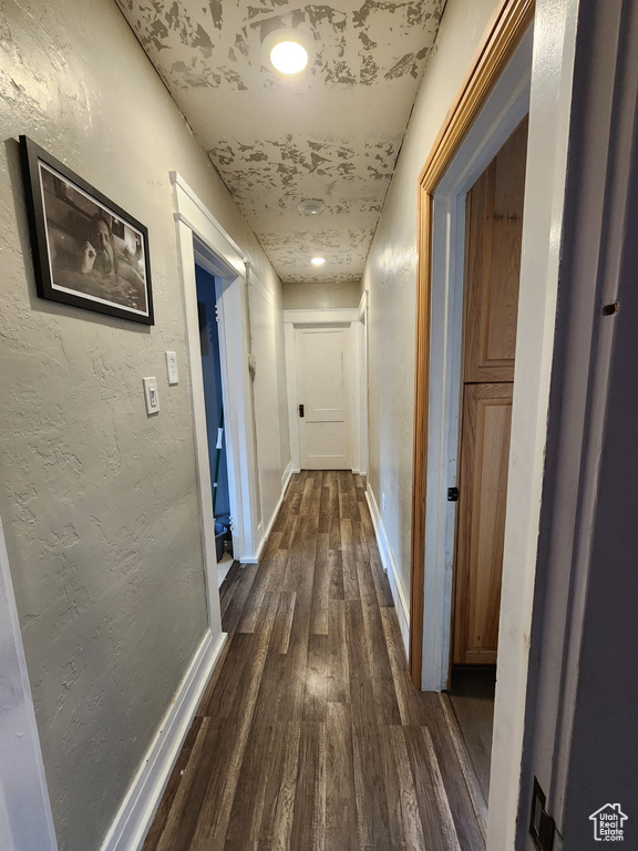 Corridor with hardwood / wood-style flooring