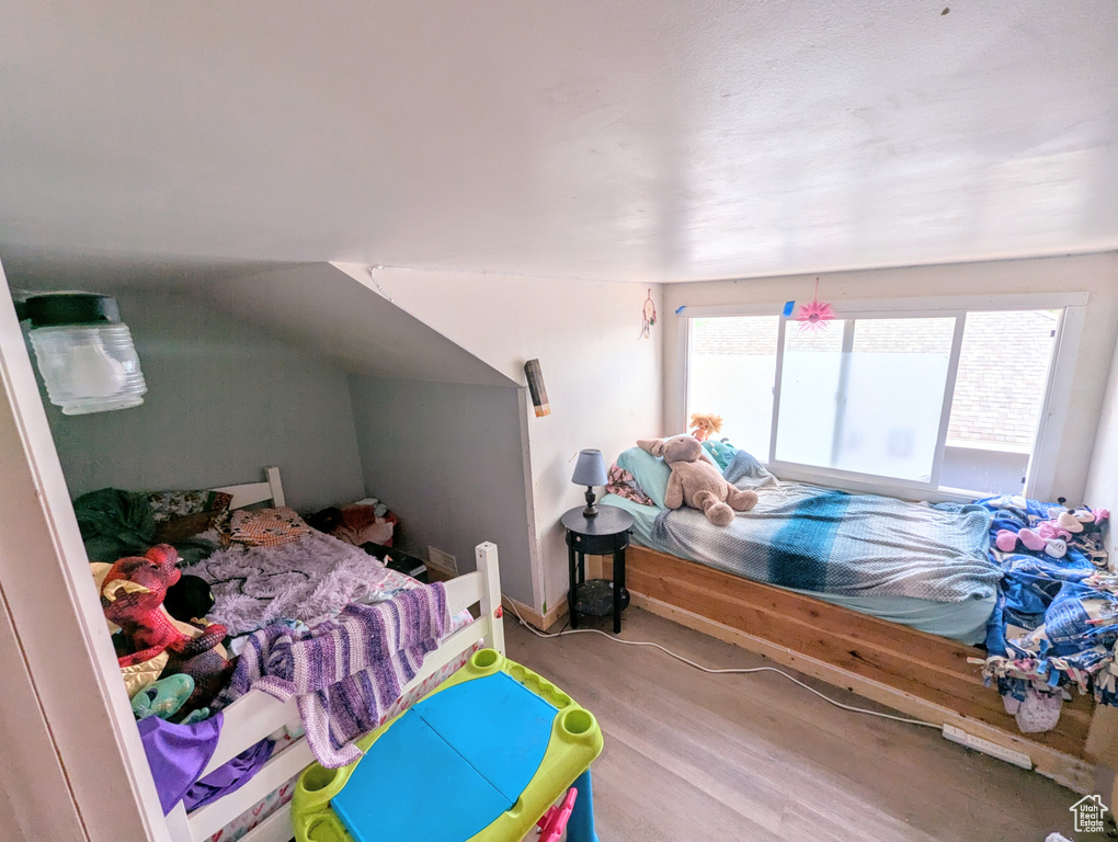 Bedroom with light hardwood / wood-style flooring