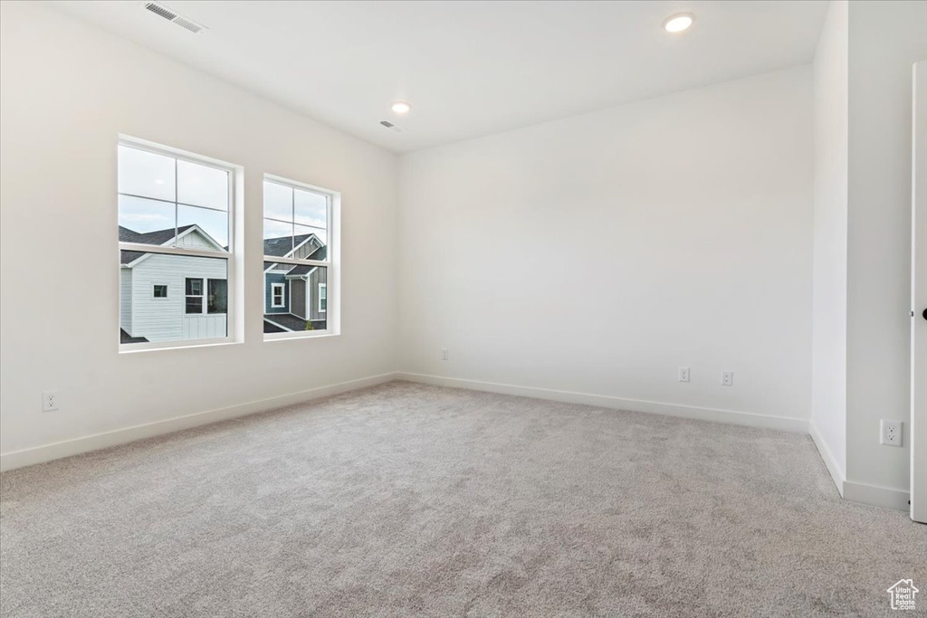 Unfurnished room with light colored carpet