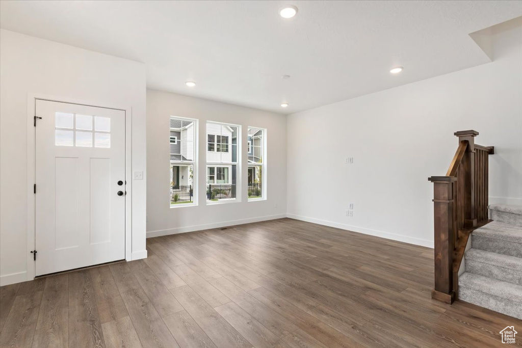 Entryway with dark hardwood / wood-style flooring and a healthy amount of sunlight